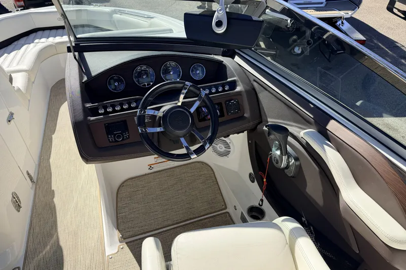 Slide: The Image of Interior view of a 2016 Cobalt R7 boat cockpit with steering wheel and controls. - 14