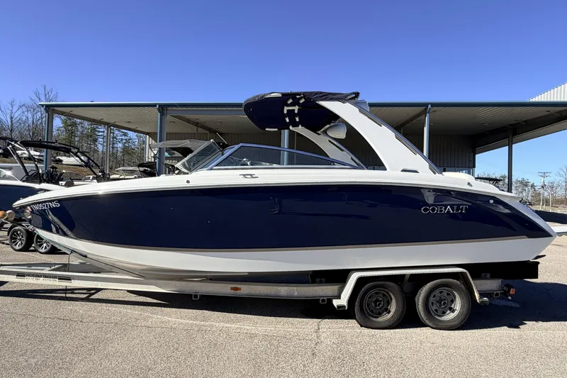 Slide: The Image of 2016 Cobalt R7 boat on trailer, parked outdoors under clear blue sky. - 22