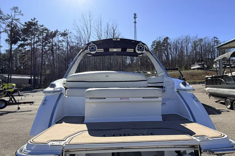 Slide: The Image of 2016 Cobalt R7 boat with spacious seating, docked outdoors under clear blue sky. - 23