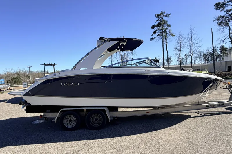 Slide: The Image of 2016 Cobalt R7 boat on trailer, parked outdoors under clear blue sky. - 26