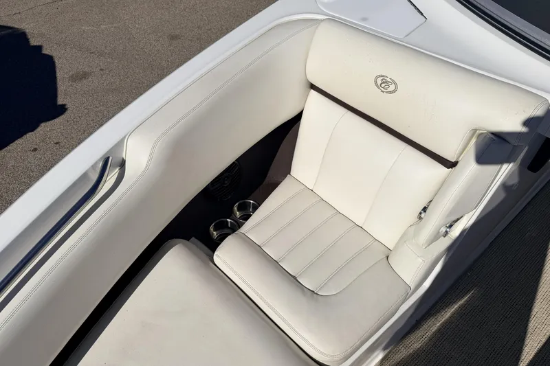Slide: The Image of White leather seat in a 2016 Cobalt R7 boat, featuring cup holders and sleek design. - 4