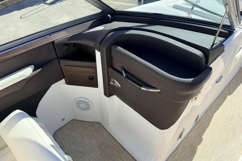 Slide: The Image of Interior of a 2016 Cobalt R7 boat, featuring sleek black and wood accents. - 8