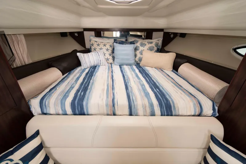 Slide: The Image of Luxurious cabin interior of 2015 Monterey 355 Sport Yacht with striped bedding and decorative pillows. - 10