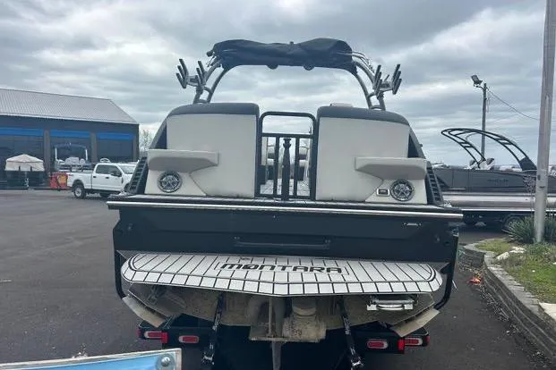 Slide: The Image of 2022 Montara 25 Surf Boss 2.0 CW boat, rear view in a parking lot. - 4