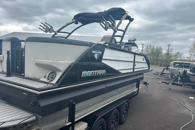 Slide: The Image of 2022 Montara 25 Surf Boss 2.0 CW boat on trailer, overcast sky background. - 5