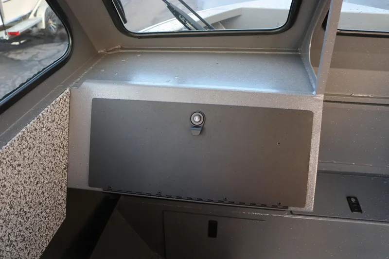 Slide: The Image of Interior view of 2026 Alumaweld Stryker 202 boat dashboard with storage compartment. - 11