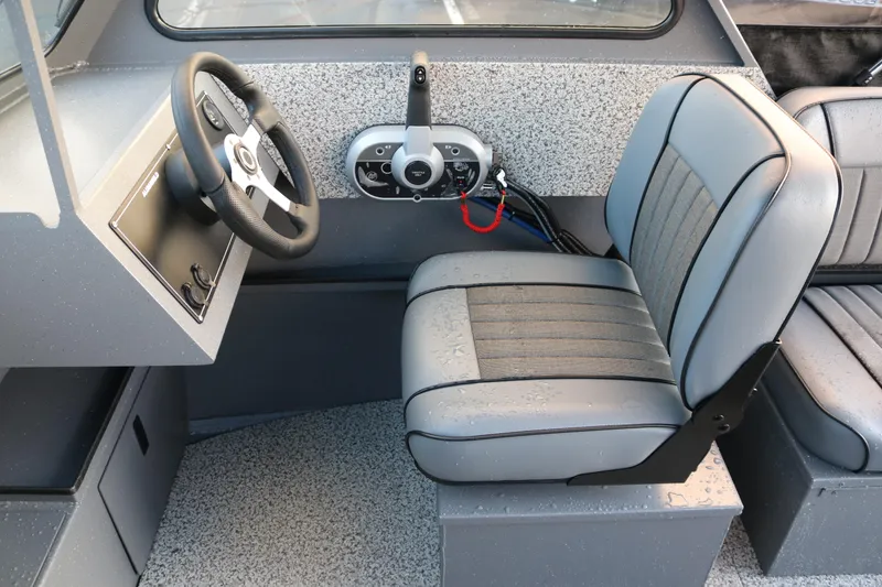 Slide: The Image of 2026 Alumaweld Stryker 202 boat interior with steering wheel and cushioned seat. - 17