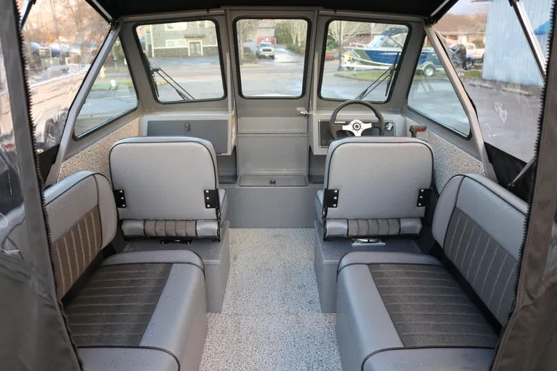 Slide: The Image of Interior of 2026 Alumaweld Stryker 202 boat, featuring gray seating and steering console. - 20