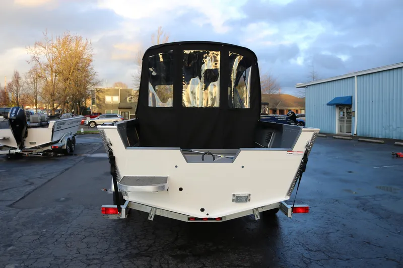 Slide: The Image of 2026 Alumaweld Stryker 202 boat, rear view, parked outdoors on a cloudy day. - 3