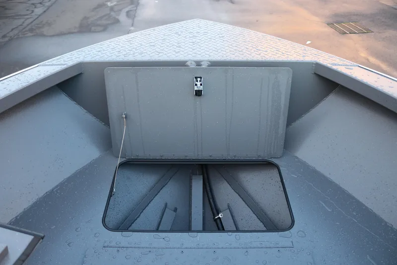 Slide: The Image of 2026 Alumaweld Stryker 202 boat storage compartment with open hatch, showing interior details. - 32