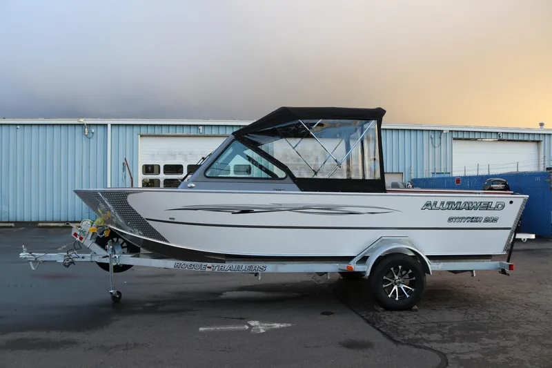 Slide: The Image of 2026 Alumaweld Stryker 202 boat on trailer, parked outside industrial building. - 5