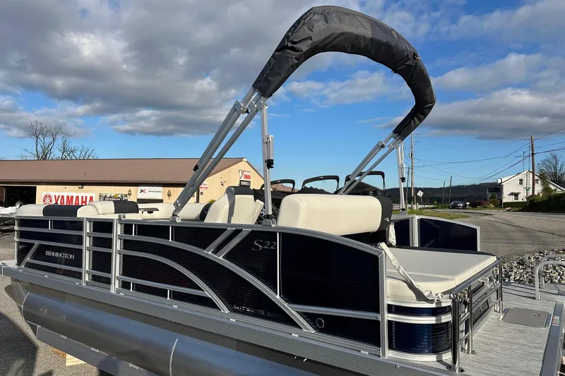 Slide: The Image of 2026 Bennington 22 SSB pontoon boat with Yamaha 90 HP engine, parked outdoors. - 11