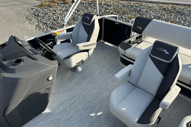 Slide: The Image of 2026 Bennington 22 SSB SwingBack interior with modern seating and steering console. - 15