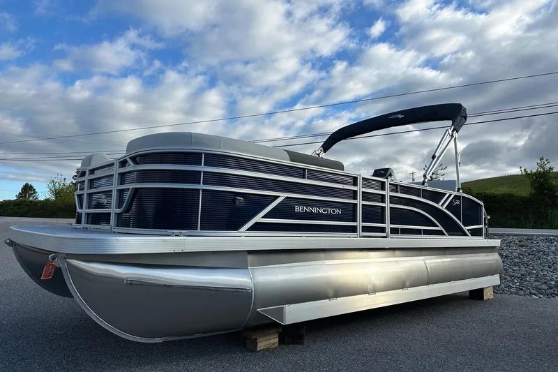 The Image of 2026 Bennington 22 SSB pontoon boat with Yamaha 90 Hp engine, parked outdoors. - 2