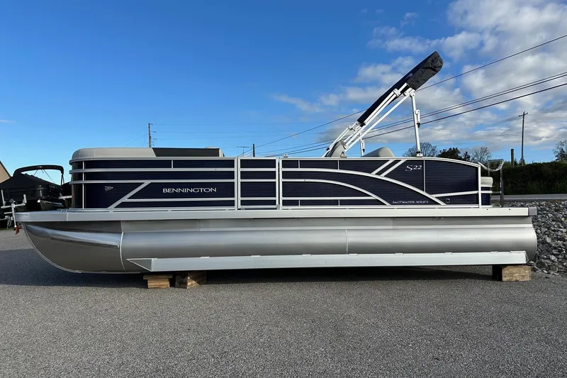 Slide: The Image of 2026 Bennington 22 SSB SwingBack pontoon boat with Yamaha 90 Hp engine, parked outdoors. - 25