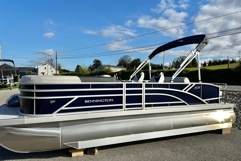 Slide: The Image of 2026 Bennington 22 SSB pontoon boat with Yamaha 90 Hp engine, parked outdoors. - 27