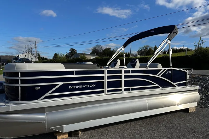 Slide: The Image of 2026 Bennington 22 SSB SwingBack pontoon boat with Yamaha 90 Hp, parked outdoors. - 30