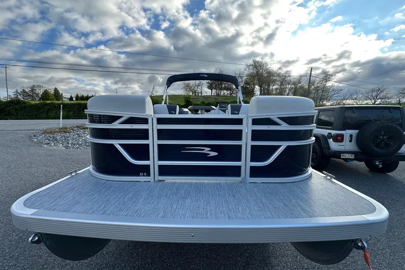 Slide: The Image of 2026 Bennington 22 SSB SwingBack pontoon boat with Yamaha 90 Hp engine, parked outdoors. - 9