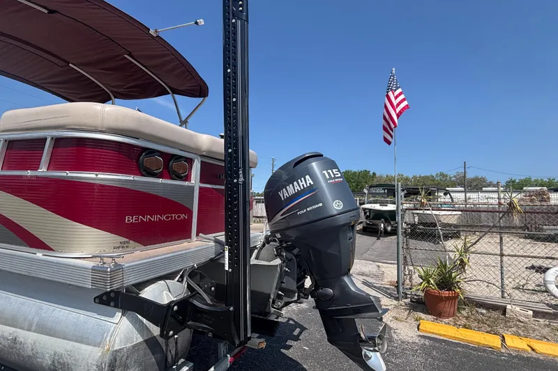 Slide: The Image of 2010 Bennington 2274GLi pontoon boat with Yamaha 115 engine, American flag in background. - 4