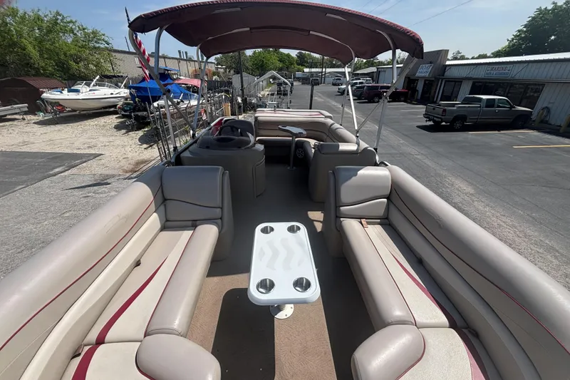 Slide: The Image of 2010 Bennington 2274GLi pontoon boat with spacious seating and canopy in a marina setting. - 7