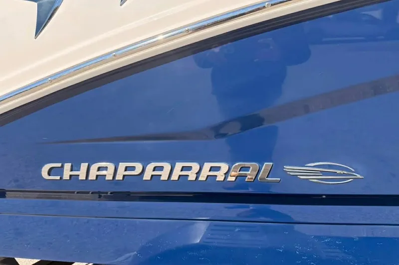 Slide: The Image of 2022 Chaparral 21 SSi OB boat logo on blue hull. - 10