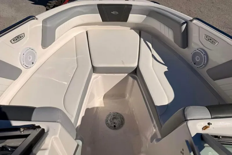 Slide: The Image of 2022 Chaparral 21 SSi OB boat interior with cushioned seating and speakers. - 14