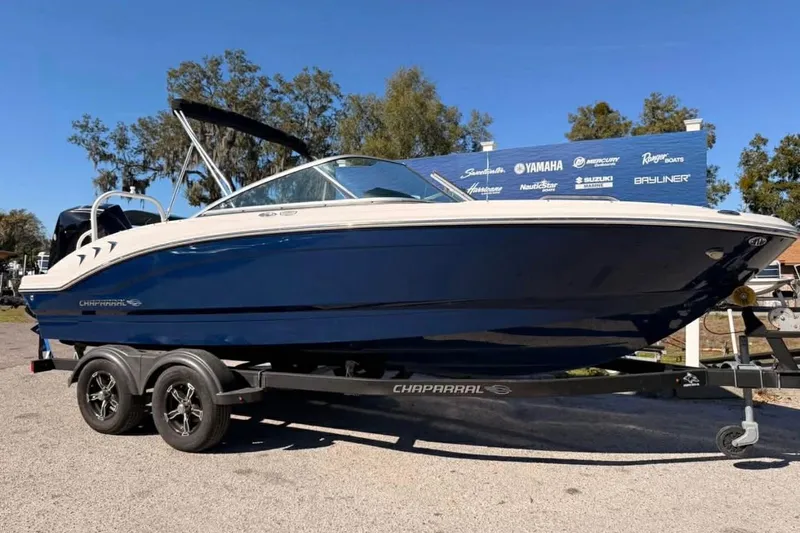 Slide: The Image of 2022 Chaparral 21 SSi OB boat on trailer, blue hull, outdoor display. - 16
