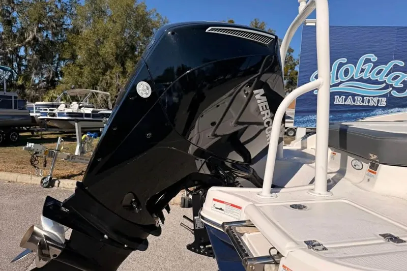 Slide: The Image of 2022 Chaparral 21 SSi OB boat with Mercury outboard motor at a marine dealership. - 9