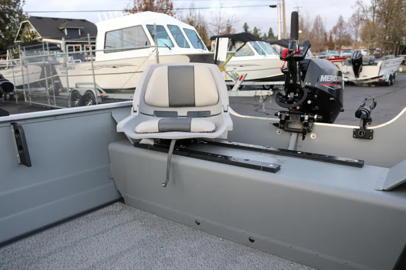 Slide: The Image of 2026 Smoker Craft Alaskan 15 boat interior with seating and Mercury motor. - 10