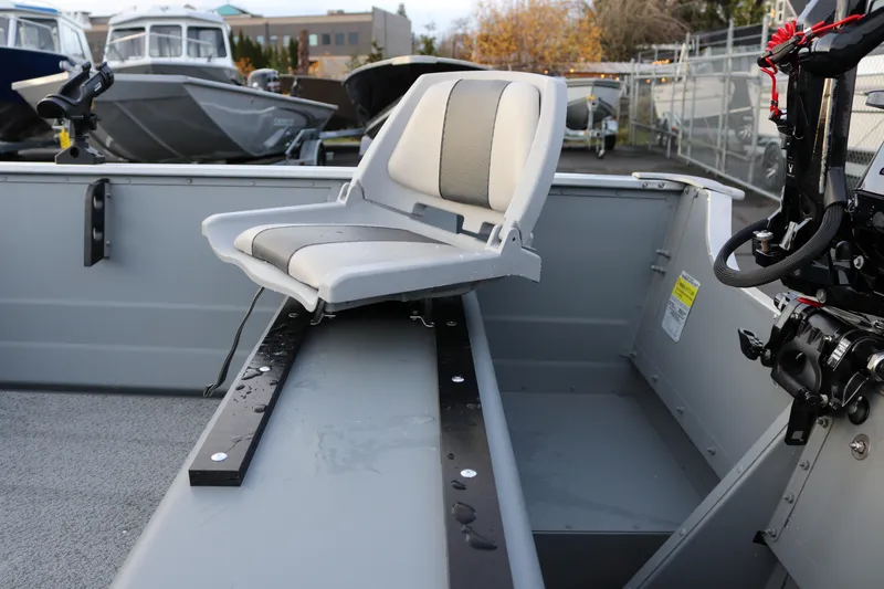 Slide: The Image of 2026 Smoker Craft Alaskan 15 boat interior with swivel seat and motor. - 12
