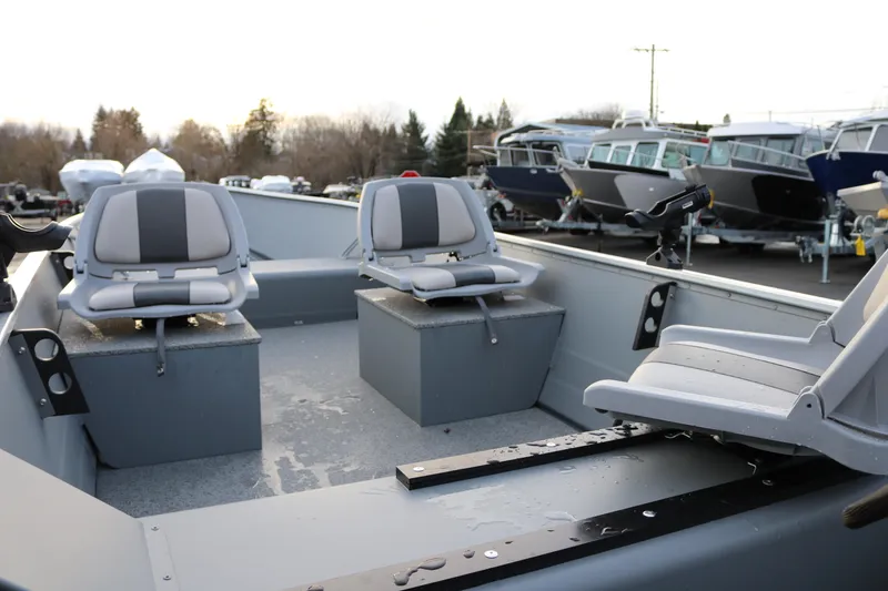Slide: The Image of 2026 Smoker Craft Alaskan 15 boat interior with seating and storage compartments. - 13