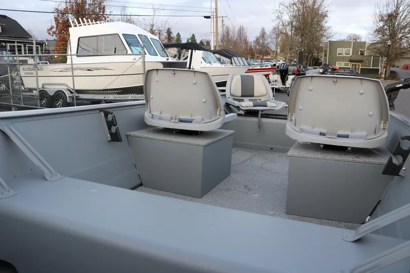 Slide: The Image of 2026 Smoker Craft Alaskan 15 boat interior with seating and storage compartments. - 9