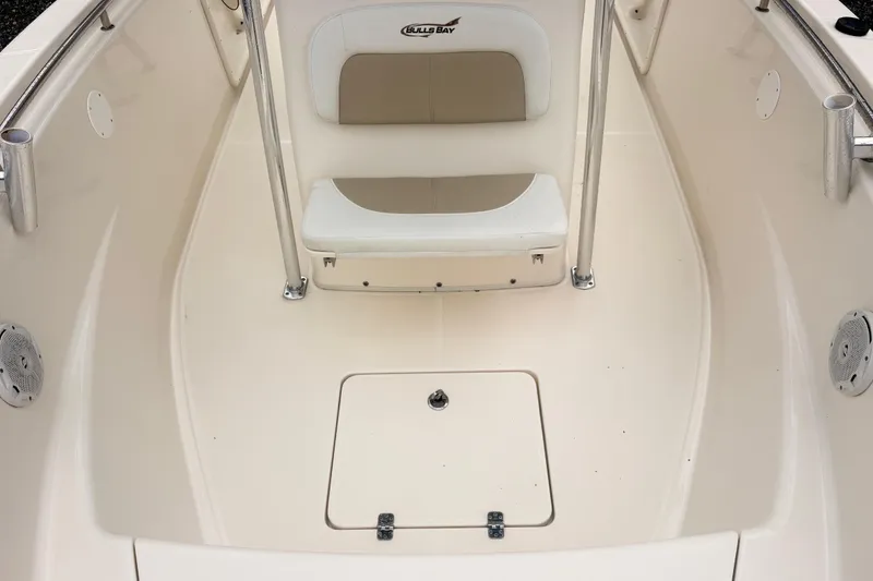 Slide: The Image of 2022 Bulls Bay 230 Center Console boat interior with seating and storage compartment. - 10