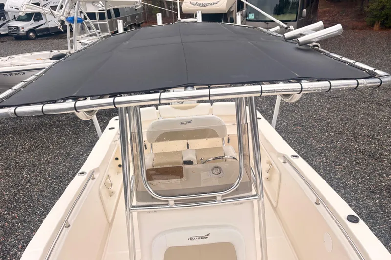 Slide: The Image of 2022 Bulls Bay 230 Center Console boat with T-top and console view. - 11