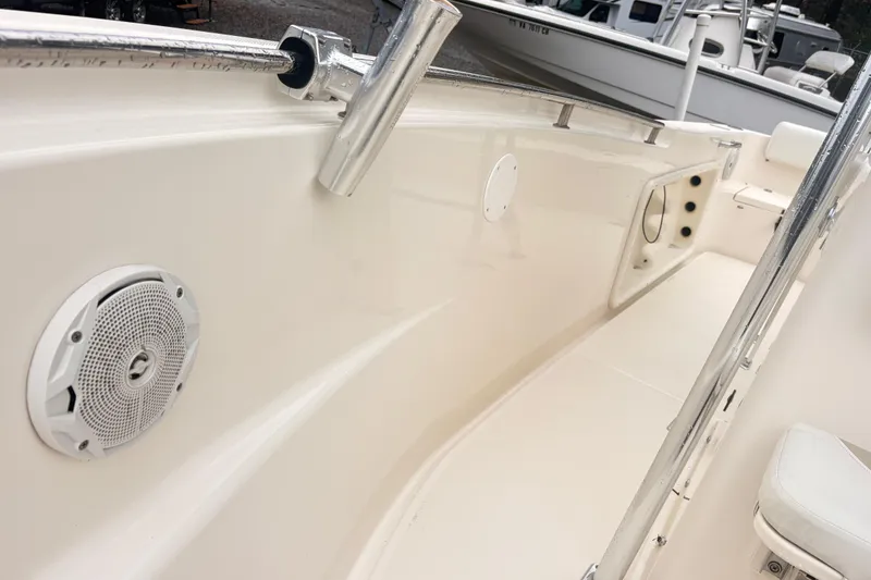 Slide: The Image of 2022 Bulls Bay 230 Center Console boat interior with speaker and rod holder. - 16