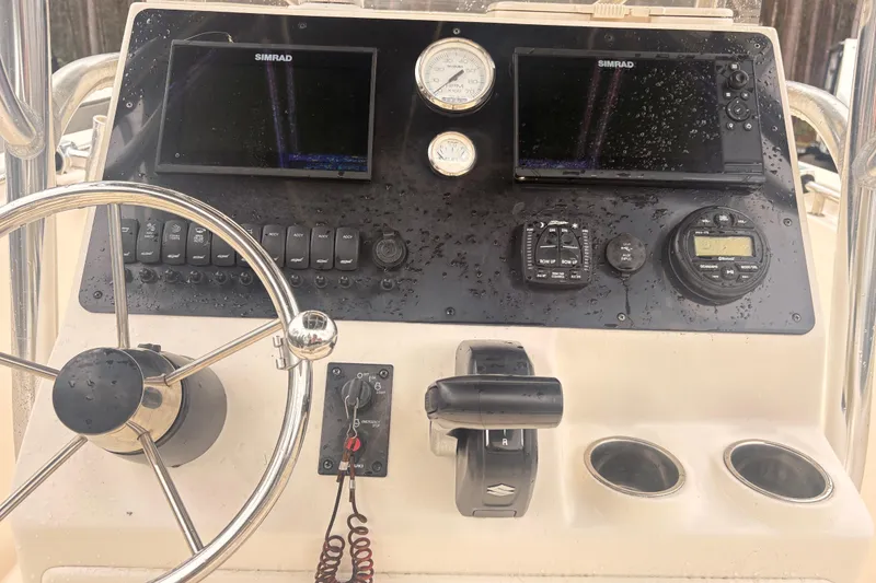 Slide: The Image of 2022 Bulls Bay 230 Center Console dashboard with steering wheel and electronic controls. - 6
