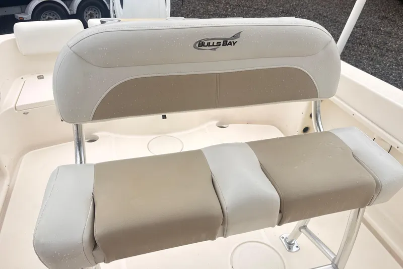 Slide: The Image of 2022 Bulls Bay 230 Center Console boat seat with beige and white upholstery. - 7
