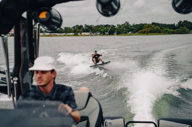 Slide: The Image of Man wakeboarding behind 2024 Montara 23 Surf Boss 2.0 CW on a lake. - 5