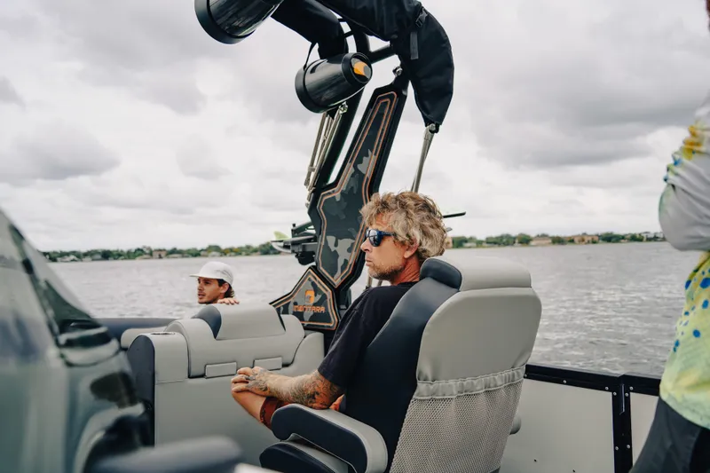 Slide: The Image of Two people relaxing on a 2024 Montara 23 Surf Boss 2.0 CW boat. - 9