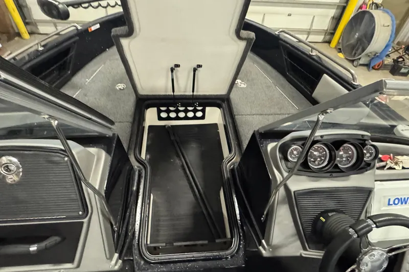 Slide: The Image of 2021 Ranger 1880MS boat interior with open storage compartment and dashboard controls. - 17
