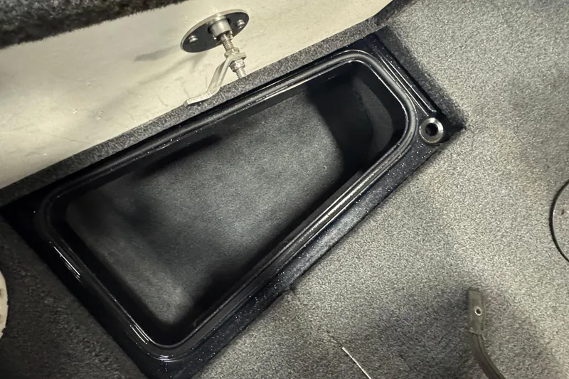 Slide: The Image of Storage compartment in 2021 Ranger 1880MS boat, featuring a sleek black interior design. - 18