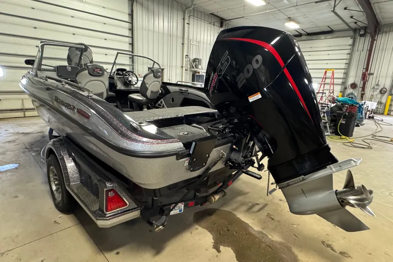 Slide: The Image of 2021 Ranger 1880MS boat with powerful outboard motor in a garage setting. - 5