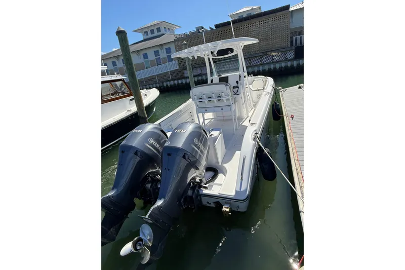 Slide: The Image of 2023 Century 2600 Center Console boat docked with twin Yamaha engines. - 10