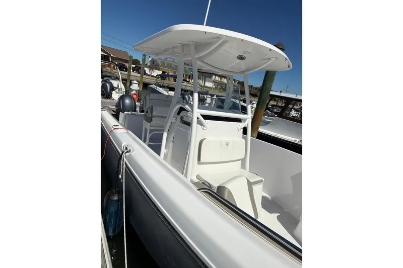 Slide: The Image of 2023 Century 2600 Center Console boat docked, featuring sleek design and modern amenities. - 12