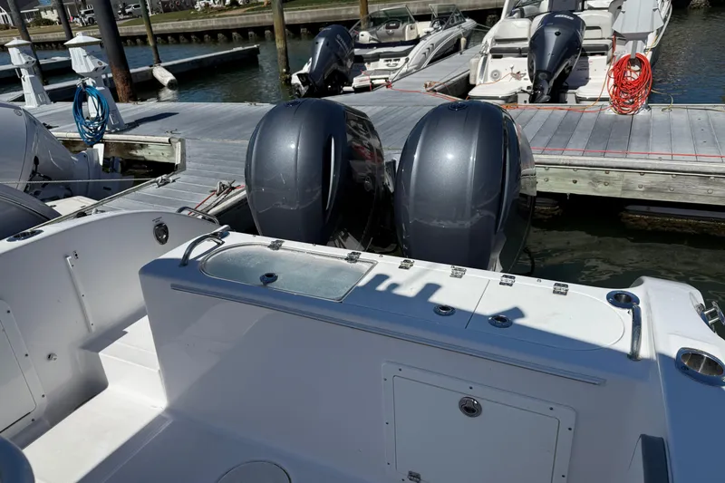 Slide: The Image of 2023 Century 2600 Center Console boat docked with twin outboard engines. - 9