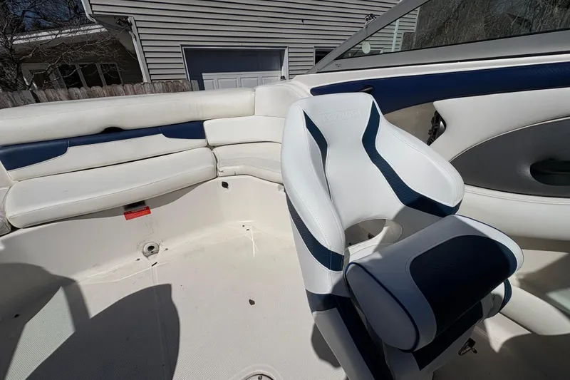 Slide: The Image of 2009 Monterey 214FS boat interior with white and blue seating. - 10