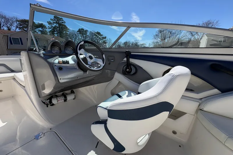 Slide: The Image of 2009 Monterey 214FS boat interior with steering wheel and dashboard controls. - 14