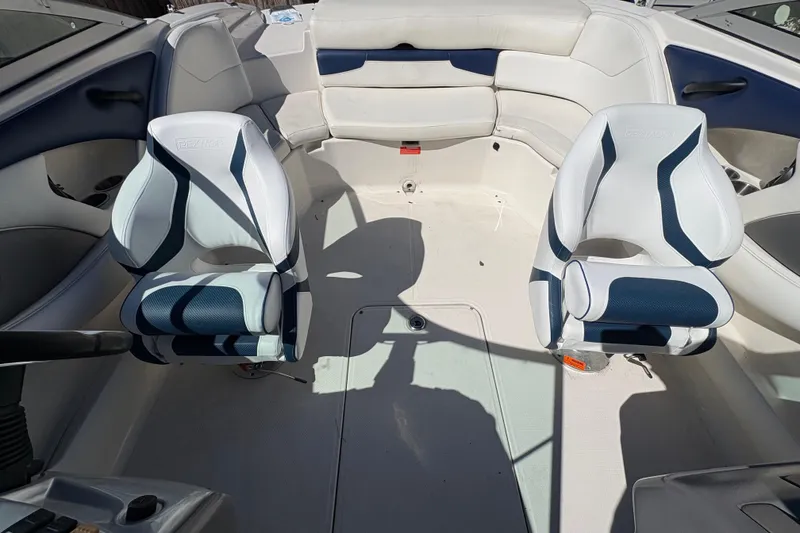 Slide: The Image of Interior of a 2009 Monterey 214FS boat with white and blue seating. - 15