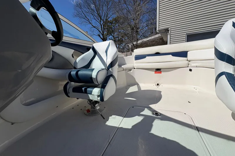 Slide: The Image of Interior of a 2009 Monterey 214FS boat with white and blue seating. - 16