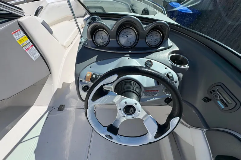 Slide: The Image of Steering console of a 2009 Monterey 214FS boat with gauges and controls. - 2